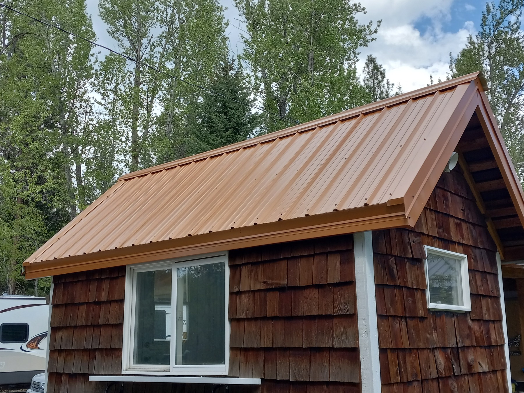Metal roofing on a wood-sided building